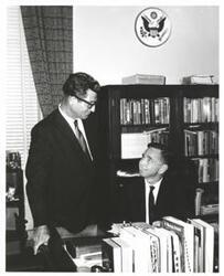 ["Black and white photograph of Carl Albert with unidentified people."]