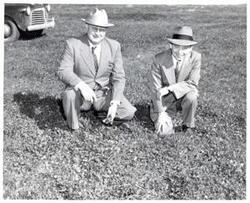 ["Black and white photograph of Carl Albert with unidentified people."]