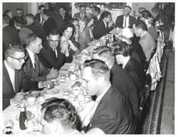 ["Black and white photograph of Carl Albert at a dinner. Page Belcher is pictured."]