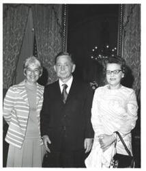 ["Black and white photograph of Carl Albert with two women."]