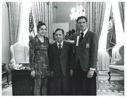 ["Black and white photograph of Carl Albert with VICA representative and unidentified woman."]