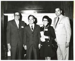 ["Black and white photograph of Carl Albert with unidentified people."]