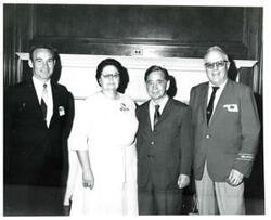 ["Black and white photograph of Carl Albert with unidentified people."]