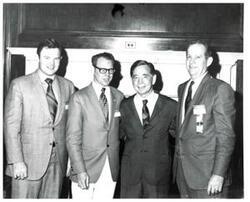 ["Black and white photograph of Carl Albert with unidentified people."]