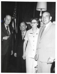 ["Black and white photograph of Carl Albert with unidentified people."]