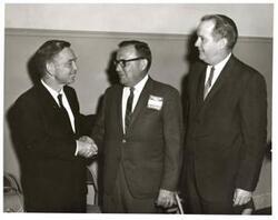 ["Black and white photograph of Carl Albert with a member of the President's Committee on Employment of the Handicapped and another man."]