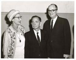 ["Black and white photograph of Carl Albert with unidentified people."]