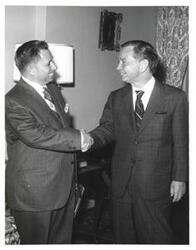 ["Black and white photograph of Carl Albert with unidentified people."]