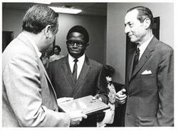 ["Black and white photograph of J. Herbert Holloman presenting Claude Johnson the 1970 Carl Albert Award. Julian Rothbaum is also pictured."]