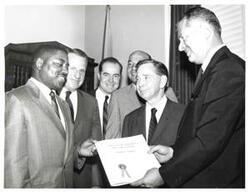 ["Black and white photograph of Carl Albert (second from right) with group presenting a Vietnam Service Decoration to Joseph Stripling (left). John N. Happy Camp and Ed Edmondson are shown."]