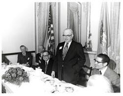 ["Black and white photograph of Tom Steed speaking at a 4-H Club award ceremony. Gerald R. Ford and Carl Albert to his right. Richard Hiendlmaye to his left. May 1974"]