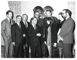 ["Black and white photograph of Carl Albert with unidentified people."]