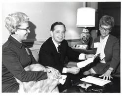 ["Black and white photograph of Carl Albert with two women from Idabel, Oklahoma hospital administration."]