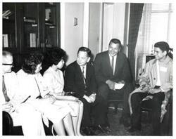 ["Black and white photograph of Carl Albert with unidentified people."]