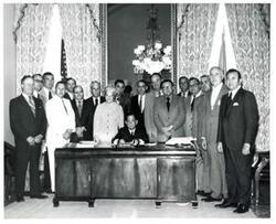 ["Black and white photograph of Carl Albert with unidentified people."]