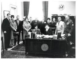 ["Black and white photograph of Carl Albert with unidentified people."]
