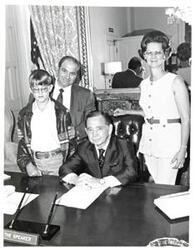["Black and white photograph of Carl Albert with an unidentified family."]