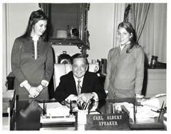 ["Black and white photograph of Carl Albert with two girls."]