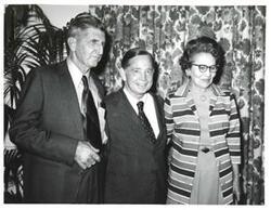 ["Black and white photograph of Carl Albert with unidentified people."]