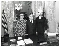 ["Black and white photograph of Carl Albert with a woman and her son. Son is in the Navy."]