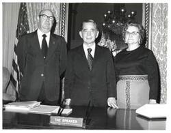 ["Black and white photograph of Carl Albert with an unidentified man and woman"]