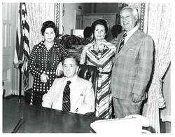 ["Black and white photograph of Carl Albert with two unidentified women and one unidentified man."]