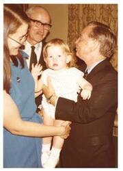 ["Color photograph of Carl Albert with baby (from Oliver Benson), and two others."]