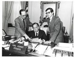 ["Black and white photograph of Carl Albert with unidentified people."]