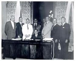 ["Black and white photograph of Carl Albert with unidentified people."]