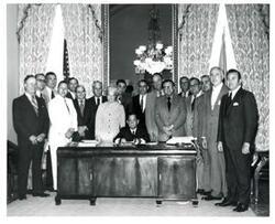 ["Black and white photograph of Carl Albert with unidentified people."]