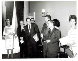 ["Black and white photograph of Carl Albert with unidentified people."]