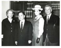 ["Black and white photograph of Carl Albert with a family."]
