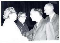 ["Black and white photograph of Carl Albert with unidentified people."]