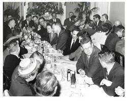 ["Black and white photograph of Carl Albert at a luncheon."]