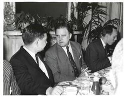 ["Black and white photograph of Carl Albert at a luncheon."]