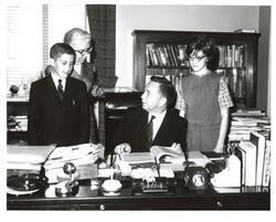 ["Black and white photograph of Carl Albert with unidentified people."]