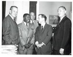 ["Black and white photograph of Carl Albert with a Vietnam Service Decoration recipient and several other men."]