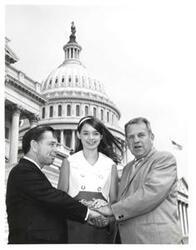 ["Black and white photograph of Carl Albert, John N. Happy Camp, and girl on the Capitol steps."]