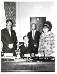 ["Black and white photograph of Carl Albert with unidentified people."]