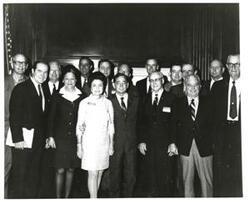 ["Black and white photograph of Carl Albert with a group."]