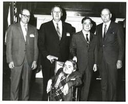 ["Black and white photograph of Carl Albert with a group from the President's Committee on Employment of the Handicapped."]
