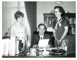 ["Black and white photograph of Carl Albert with unidentified people."]