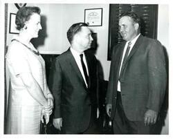 ["Black and white photograph of Carl Albert with unidentified people."]
