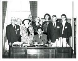 ["Black and white photograph of Carl Albert with unidentified people."]