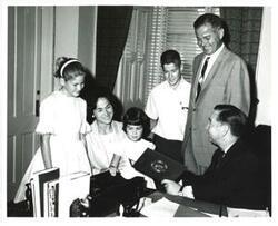 ["Black and white photograph of Carl Albert with Reverend Richard Gibbons and family."]