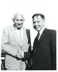 ["Black and white photograph of Carl Albert with a man."]