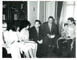 ["Black and white photograph of Carl Albert with unidentified people."]