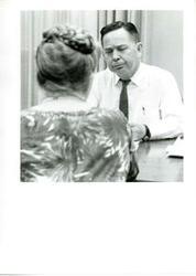 ["Black and white photograph of Carl Albert with unidentified people."]