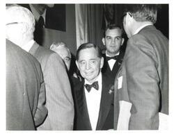 ["Black and white photograph of Carl Albert at a banquet."]