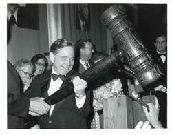 ["Black and white photograph of Carl Albert receiving a giant honorary gavel."]